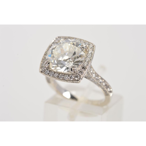 50 - A STUNNING MODERN LARGE DIAMOND RING, centring on a transitional round brilliant cut diamond, enclos... 