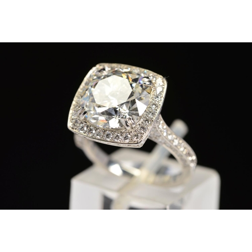 50 - A STUNNING MODERN LARGE DIAMOND RING, centring on a transitional round brilliant cut diamond, enclos... 