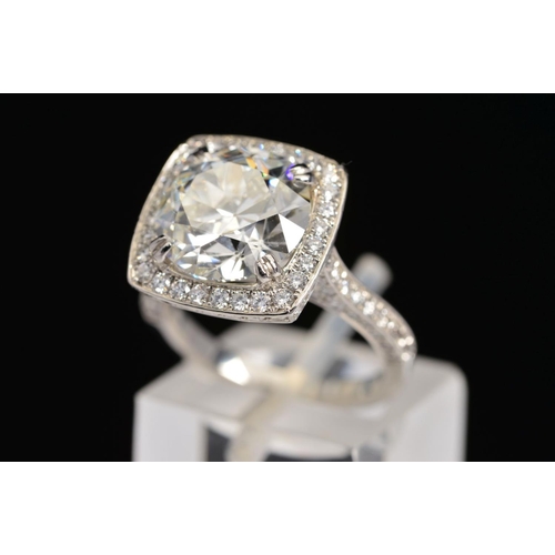 50 - A STUNNING MODERN LARGE DIAMOND RING, centring on a transitional round brilliant cut diamond, enclos... 