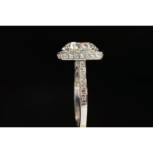 50 - A STUNNING MODERN LARGE DIAMOND RING, centring on a transitional round brilliant cut diamond, enclos... 