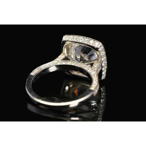 50 - A STUNNING MODERN LARGE DIAMOND RING, centring on a transitional round brilliant cut diamond, enclos... 