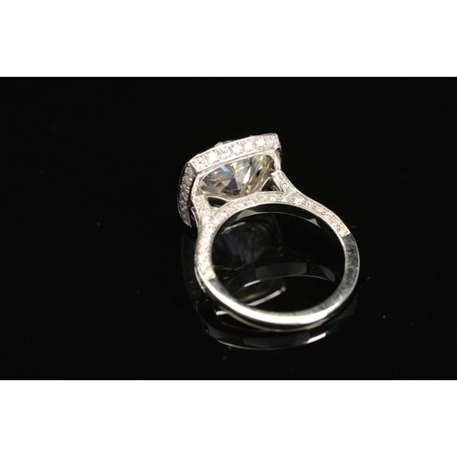 50 - A STUNNING MODERN LARGE DIAMOND RING, centring on a transitional round brilliant cut diamond, enclos... 