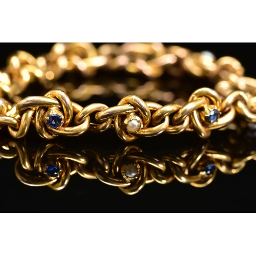 53 - AN EARLY 20TH CENTURY GOLD, SAPPHIRE AND SEED PEARL BRACELET, designed as a twisted curb link bracel... 