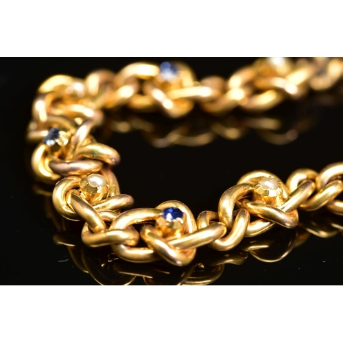 53 - AN EARLY 20TH CENTURY GOLD, SAPPHIRE AND SEED PEARL BRACELET, designed as a twisted curb link bracel... 