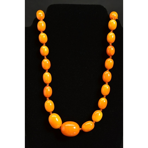 7 - A NATURAL AMBER NECKLACE, designed as fifty-five graduated beads measuring approximately 13mm to 27m... 