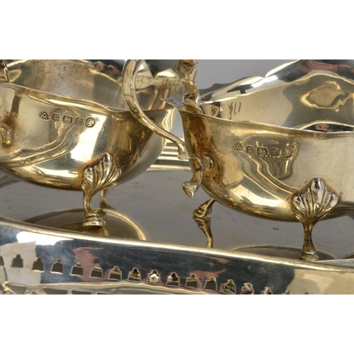 83 - A PAIR OF GEORGE V SILVER OVAL SAUCE BOATS, wavy rims, 'S' scroll handles, on cabriole legs with hoo... 