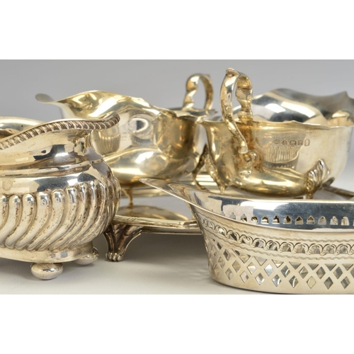 83 - A PAIR OF GEORGE V SILVER OVAL SAUCE BOATS, wavy rims, 'S' scroll handles, on cabriole legs with hoo... 