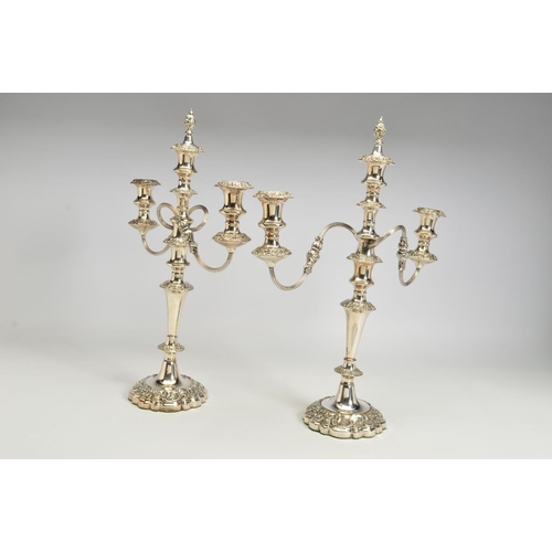 99 - A PAIR OF VICTORIAN OLD SHEFFIELD PLATE THREE BRANCH CANDELABRA, each with detachable foliate flame ... 