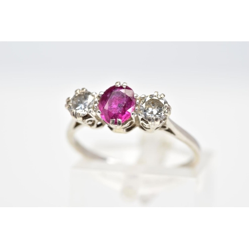 112 - A RUBY AND DIAMOND RING, set with a central oval cut ruby flanked with brilliant cut diamonds, withi... 