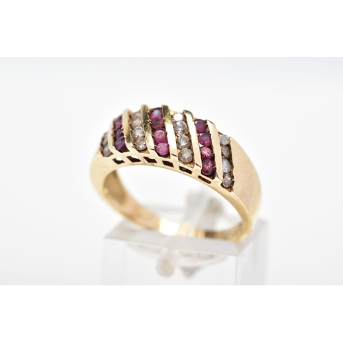 113 - A DIAMOND AND RUBY RING, designed with four diagonal rows of round brilliant cut diamonds interspace... 