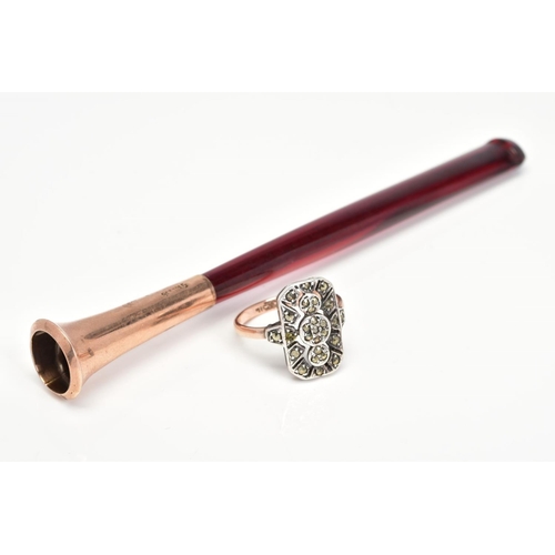 122 - AN EARLY 20TH CENTURY CIGARETTE HOLDER AND MARCASITE RING, the tapered red plastic cigarette holder ... 