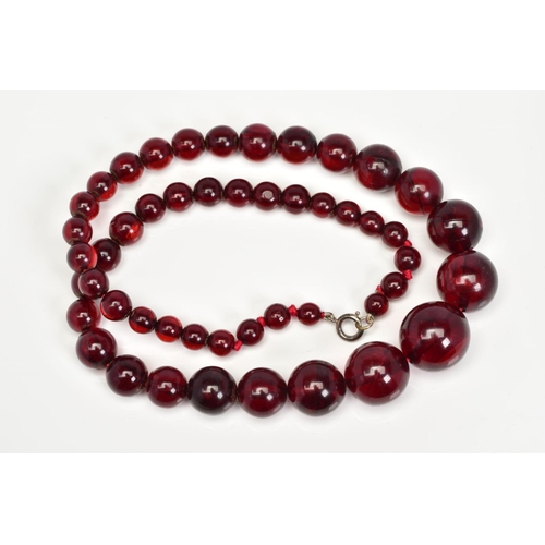 123 - A RED PLASTIC BEAD NECKLACE, designed as graduated spherical beads measuring approximately 6mm to 20... 