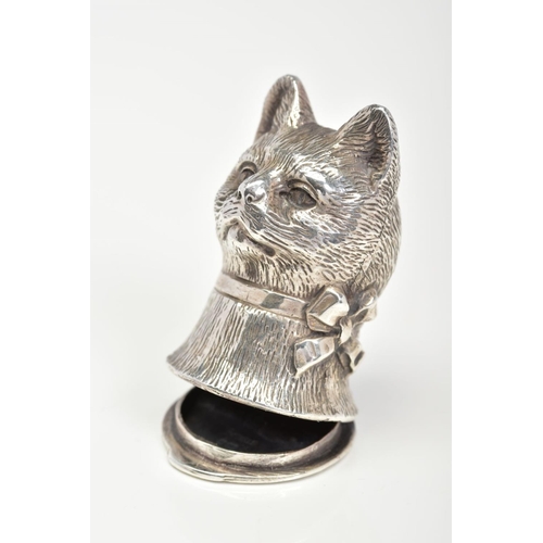 125 - A CAT VESTA CASE, designed as a cat head with a ribbon round its neck, to the hinged base with scrol... 