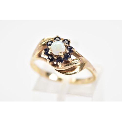 13 - A 9CT GOLD OPAL AND SAPPHIRE CLUSTER RING, designed as a central circular opal cabochon within a cir... 