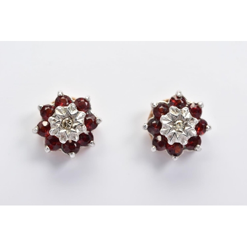 132 - A PAIR OF 9CT GOLD GARNET AND DIAMOND CLUSTER EARRINGS, the stud earrings each designed as a central... 