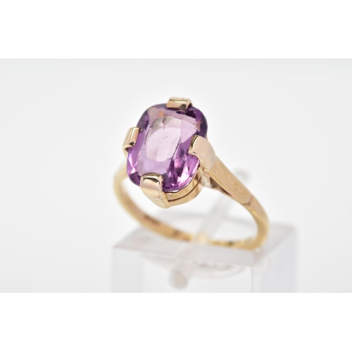 139 - A PURPLE PASTE RING, designed with a cushion shape purple paste in a four claw setting to the plain ... 