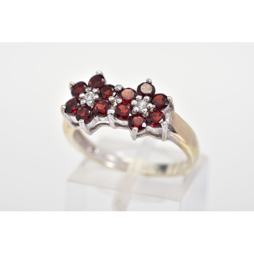 146 - A 9CT GOLD GARNET AND DIAMOND RING, designed as two flowers each with six circular cut garnets with ... 