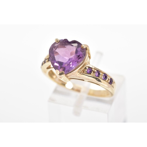 150 - A 9CT GOLD AMETHYST RING, the heart shape amethyst within a three claw setting to the amethyst set s... 