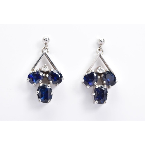 155 - A PAIR OF SAPPHIRE DROP EARRINGS, each designed with three oval cut sapphires and a single brilliant... 