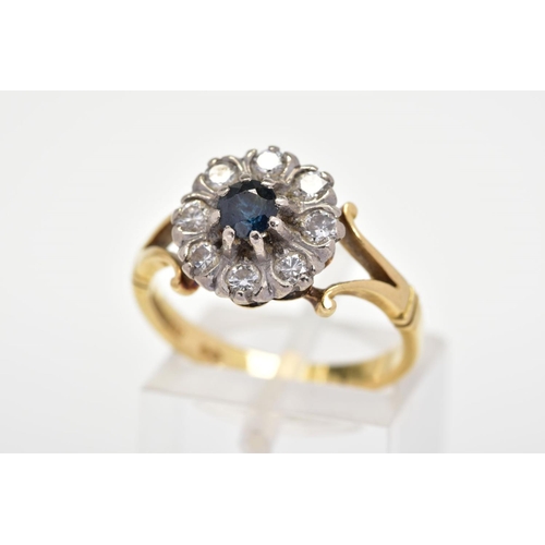 158 - A SAPPHIRE AND DIAMOND CLUSTER RING, designed as a central circular blue sapphire within a brilliant... 