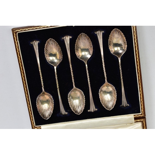 221 - A CASED SET OF SIX SILVER TEASPOONS, each with shell design bowls, twisted stems and tapered scrolli... 