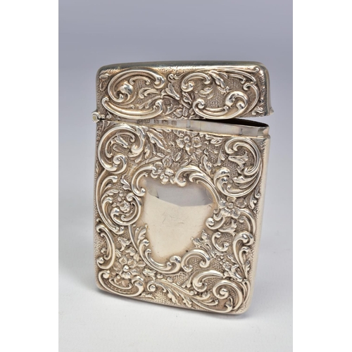 66 - AN EDWARDIAN SILVER CARD CASE OF RECTANGULAR FORM, repousse decorated with foliate scrolls, vacant c... 