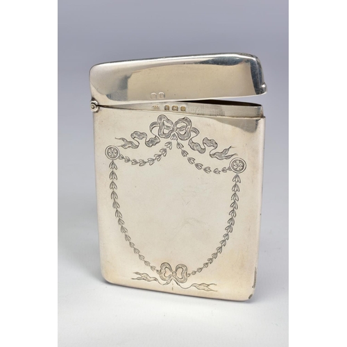 67 - AN EDWARDIAN SILVER CARD CASE OF RECTANGULAR FORM, engraved with ribbons and swags in the shape of a... 