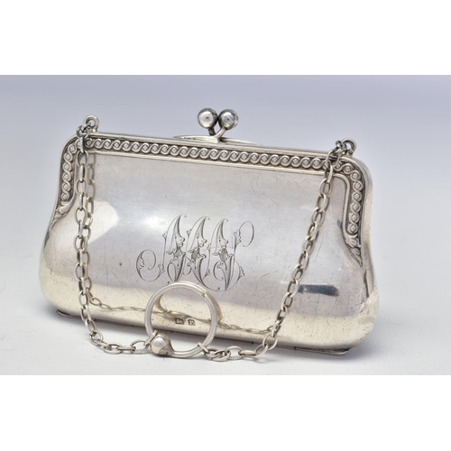 71 - A GEORGE V SILVER PURSE, scrolled edges, engraved initials, on a chain with finger ring, brown leath... 