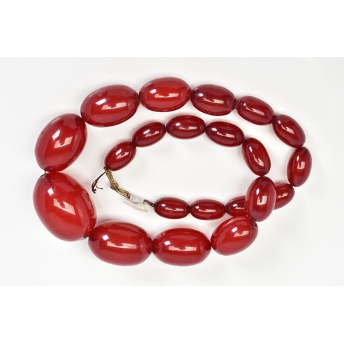 89 - A RED PLASTIC BEAD NECKLACE, comprising of a graduated row of oval beads, measuring 12mm to 30mm, le... 