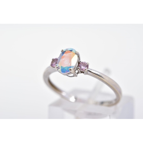 92 - A 9CT WHITE GOLD CUBIC ZIRCONIA RING, designed as a central oval opalescent cubic zirconia flanked b... 