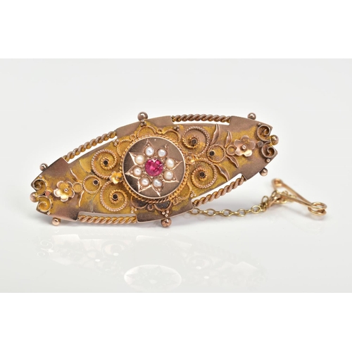 97 - AN EARLY 20TH CENTURY 9CT GOLD GEM SET BROOCH, of oval outline set with a central circular red gem w... 