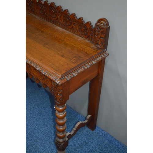 1689 - AN EARLY 20TH CENTURY CARVED OAK HALL TABLE decorated with foliate and roundel decoration, the table... 