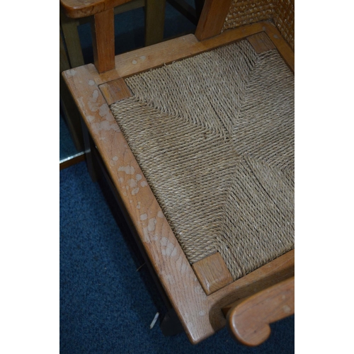 1694 - AN EARLY 20TH CENTURY LIGHT OAK ORKNEY CHAIR, the curved woven straw back flanked by open arm rests,... 