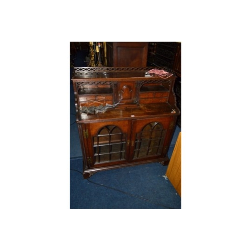 1680 - A 19TH CENTURY AND LATER OAK GLAZED TWO DOOR CABINET in the form of an open bureau, with a fretwork ... 