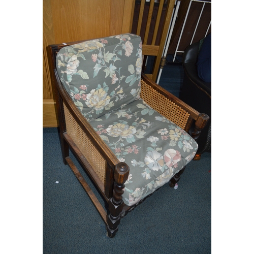 1697 - AN EARLY 20TH CENTURY OAK BERGERE ARMCHAIR with removable cushions