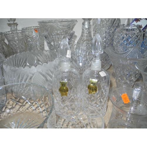 943 - A COLLECTION OF MOSTLY CUT GLASS GLASSWARE, to include decanters, vases, bowls, water glasses, desse... 