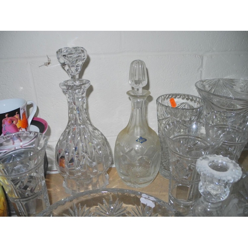 943 - A COLLECTION OF MOSTLY CUT GLASS GLASSWARE, to include decanters, vases, bowls, water glasses, desse... 