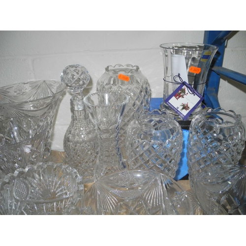 943 - A COLLECTION OF MOSTLY CUT GLASS GLASSWARE, to include decanters, vases, bowls, water glasses, desse... 