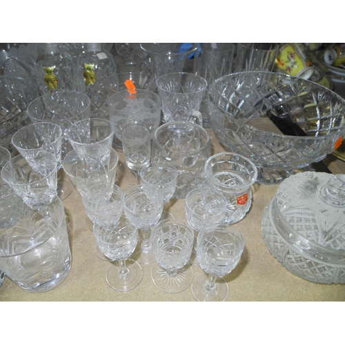 943 - A COLLECTION OF MOSTLY CUT GLASS GLASSWARE, to include decanters, vases, bowls, water glasses, desse... 