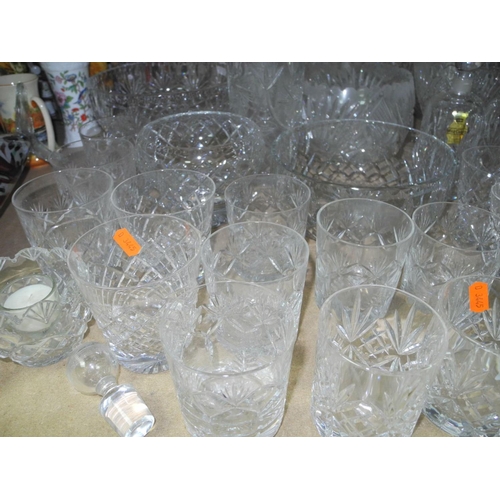 943 - A COLLECTION OF MOSTLY CUT GLASS GLASSWARE, to include decanters, vases, bowls, water glasses, desse... 