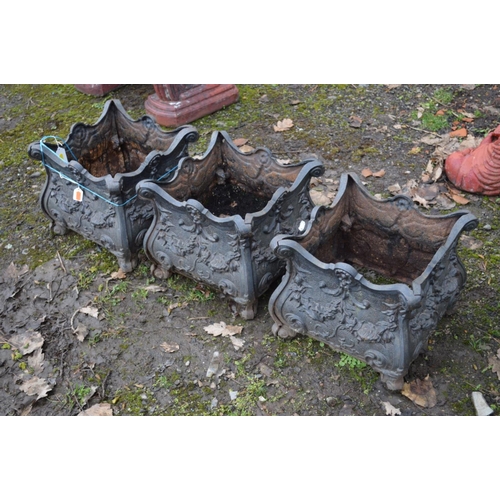 76 - THREE BLACK GROUND CAST IRON GARDEN PLANTERS, with foliate decoration, 34cm square