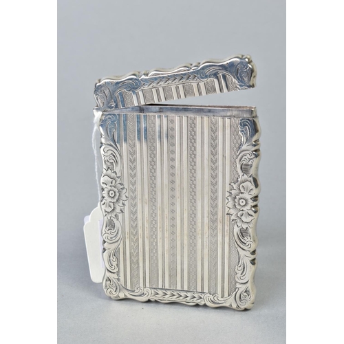 103 - A LATE VICTORIAN SILVER CARD CASE OF WAVY RECTANGULAR OUTLINE, foliate engraved and engine turned wi... 