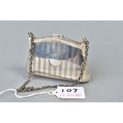 107 - A GEORGE V SILVER PURSE, engine turned decoration, fabric lined interior, on a chain and finger ring... 