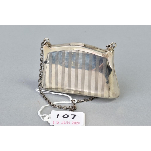 107 - A GEORGE V SILVER PURSE, engine turned decoration, fabric lined interior, on a chain and finger ring... 