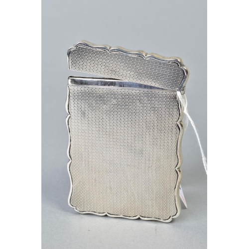 108 - A MID VICTORIAN SILVER CARD CASE OF WAVY RECTANGULAR FORM, hinged top, engine turned decoration, cir... 