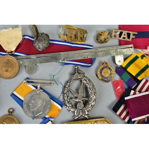 111 - A SMALL BOX OF MILITARIA, to include cap badges, two defence medals 1939-45, a military style wristw... 