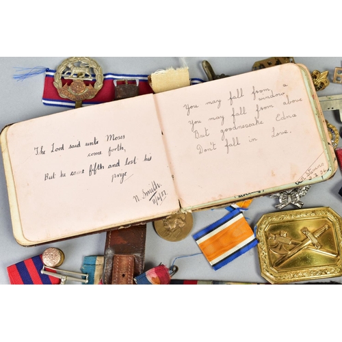 111 - A SMALL BOX OF MILITARIA, to include cap badges, two defence medals 1939-45, a military style wristw... 