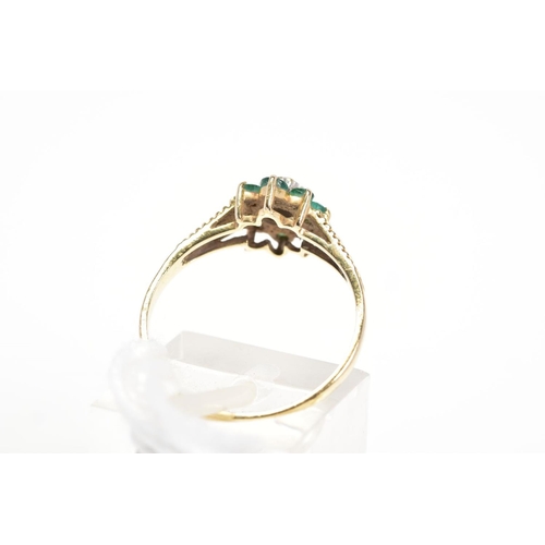 13 - A 9CT GOLD EMERALD AND DIAMOND CLUSTER RING, the central single cut diamond within a star illusion s... 