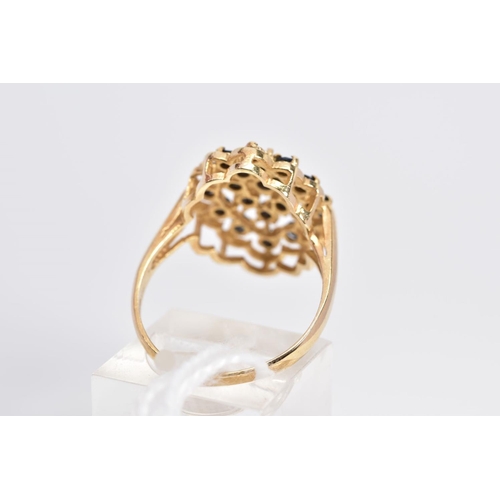 14 - A 9CT GOLD SAPPHIRE DRESS RING, designed as an openwork panel with scalloped edge, claw set with cir... 