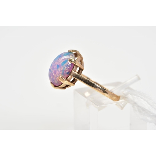 15 - A 9CT GOLD DRESS RING, designed with an oval foil glass cabochon imitating an opal in a six claw set... 